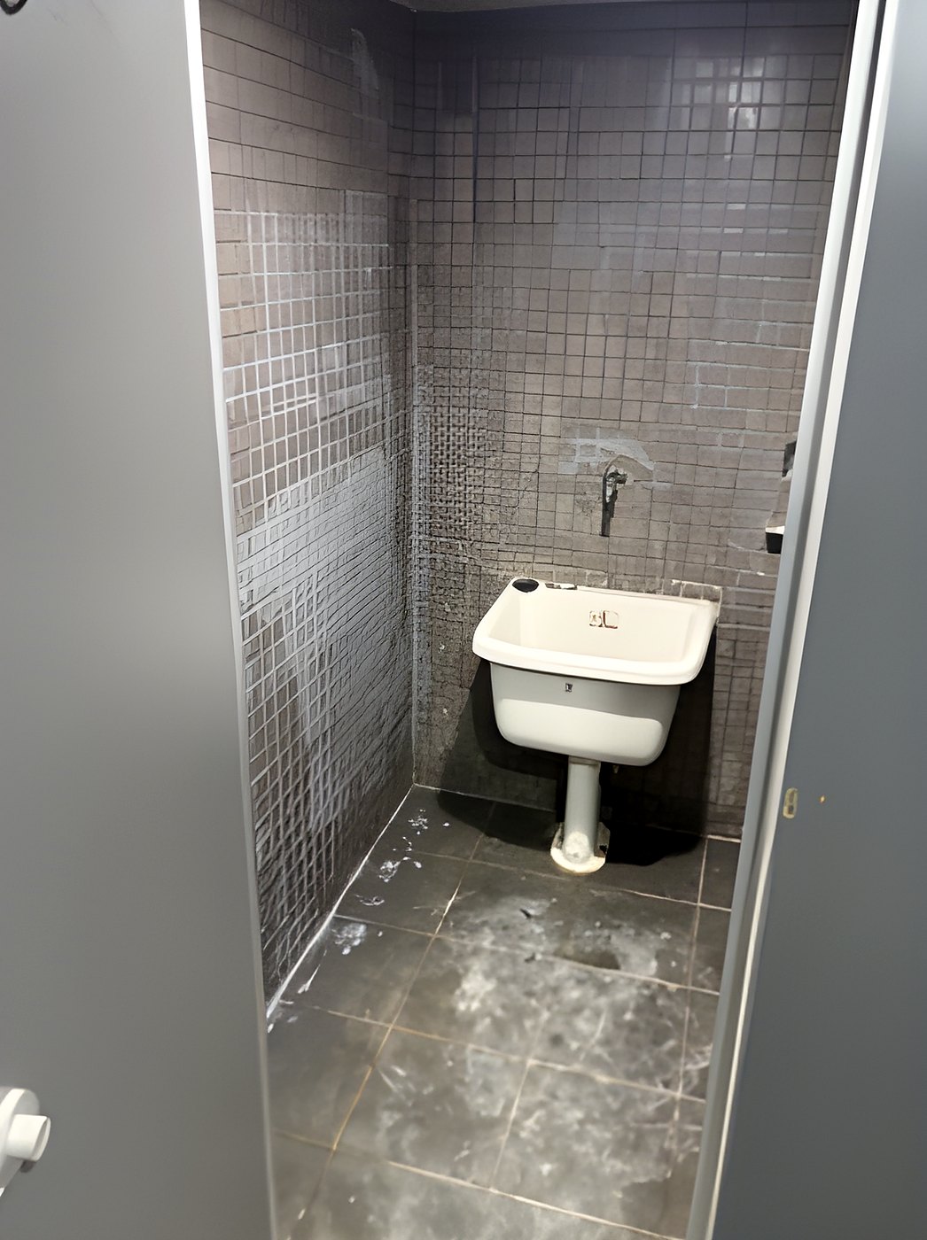 Nianqing Youwei Masonry | Mop sink stall tiling in progress